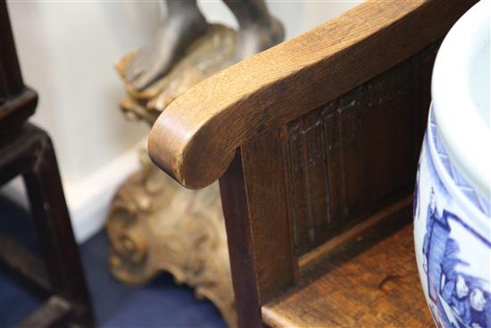 An Edwardian carved oak bench seat, formerly from Christs Hospital, Sussex, W.7ft